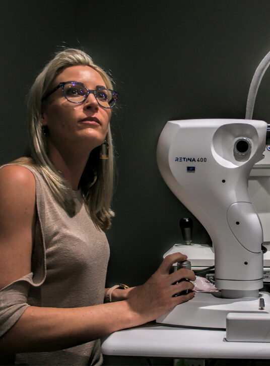 Optometrist Aretha Coetzee at the retinal camera in her practice