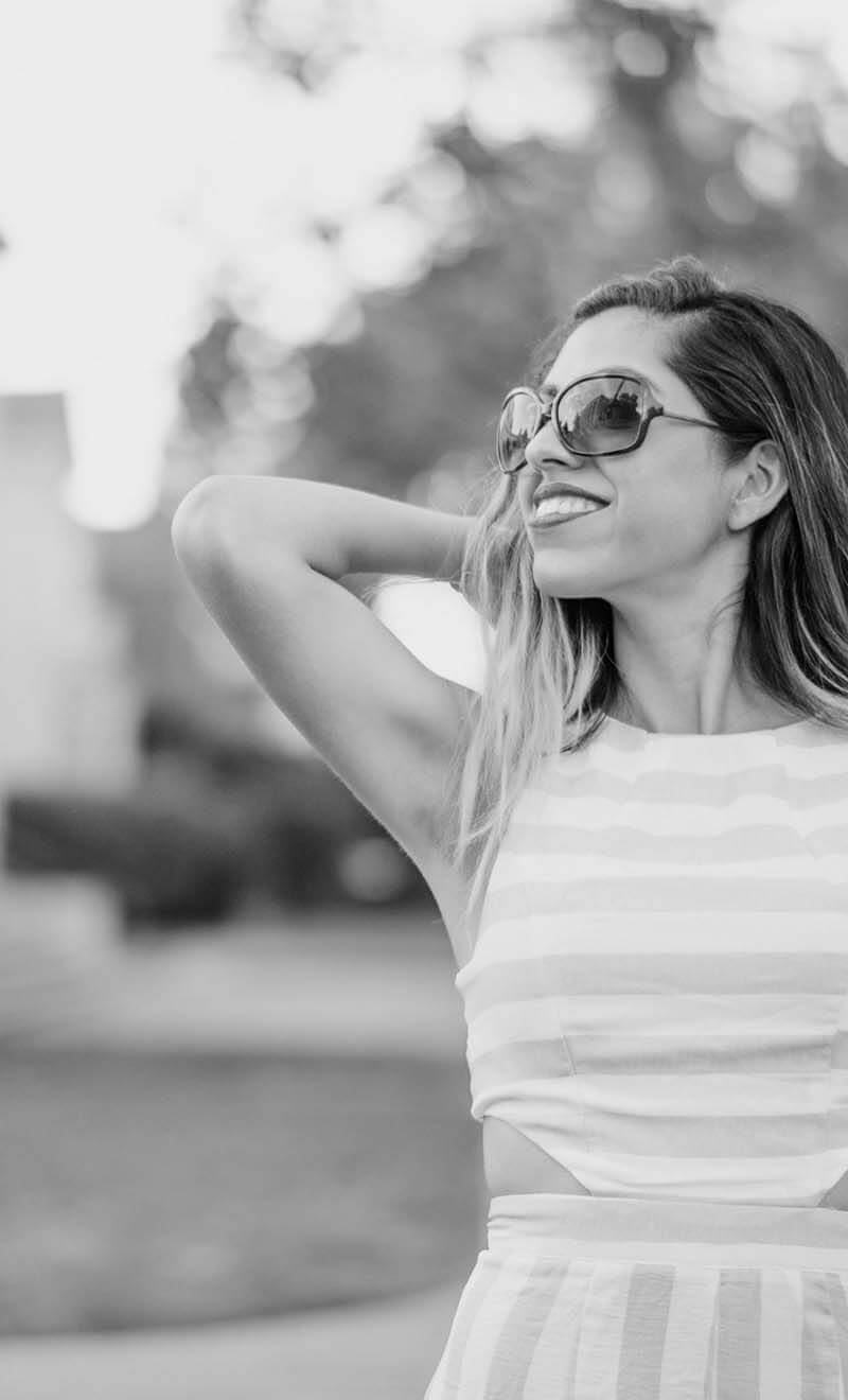 Black and white photo of a woman in large sunglasses looking to the side
